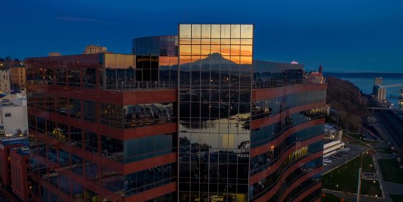 A downtown city building in Tacoma reflecting the sunset